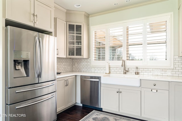 kitchen with appliances with stainless steel finishes, dark hardwood / wood-style floors, tasteful backsplash, white cabinetry, and sink