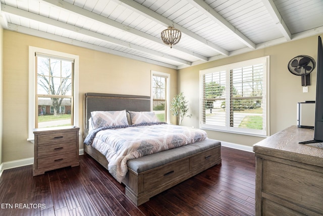 bedroom with multiple windows, dark hardwood / wood-style flooring, and beamed ceiling