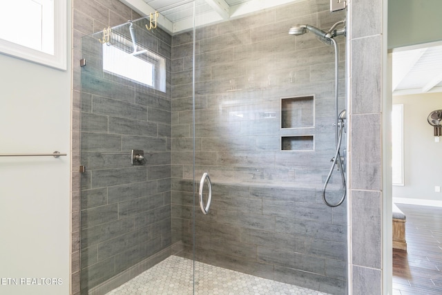 bathroom with a shower with door