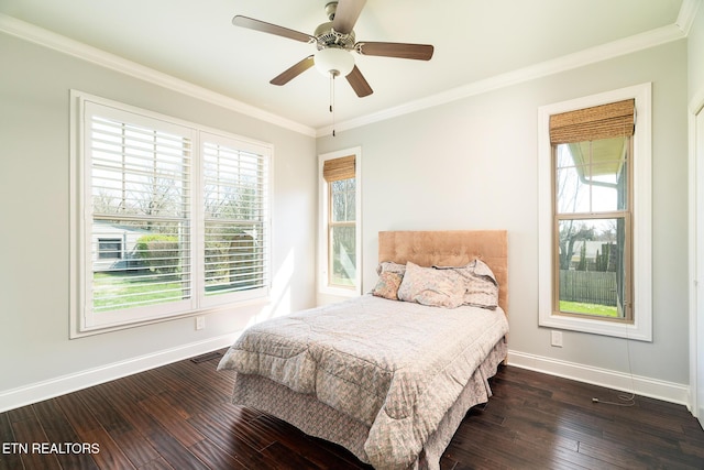 bedroom featuring crown molding, dark wood-type flooring, and ceiling fan