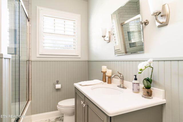 full bathroom with vanity, toilet, and combined bath / shower with glass door