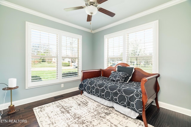 bedroom featuring crown molding, ceiling fan, and dark wood-type flooring