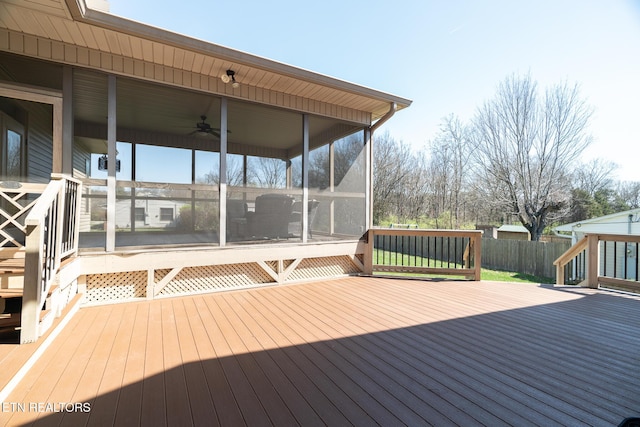 deck with a sunroom and ceiling fan