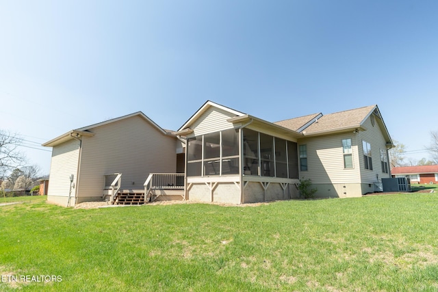 back of property with a deck, central air condition unit, a sunroom, and a lawn