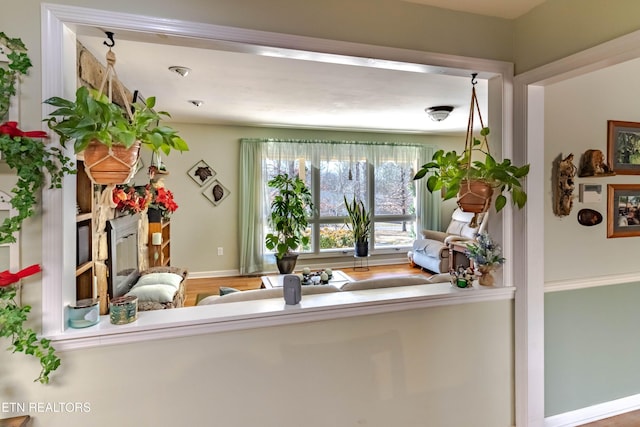 interior space featuring baseboards and wood finished floors