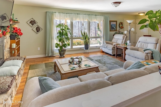 living room featuring light wood finished floors and baseboards