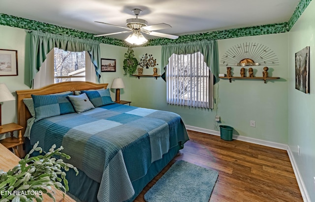 bedroom featuring ceiling fan, dark wood-style flooring, and baseboards