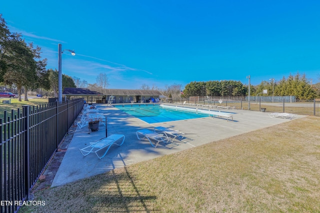 view of swimming pool featuring a patio area and a lawn