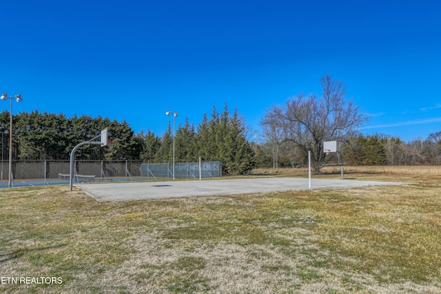 view of basketball court with a lawn