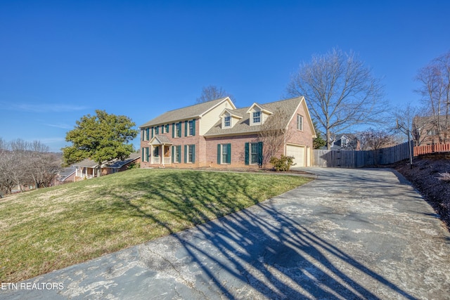 view of front of house with a garage and a front lawn