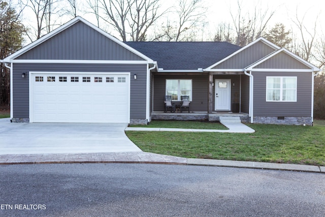 single story home featuring a front lawn, crawl space, concrete driveway, and a garage