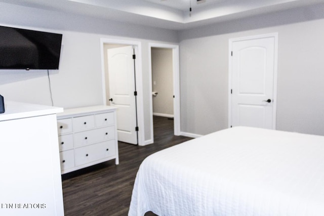 bedroom with dark hardwood / wood-style flooring