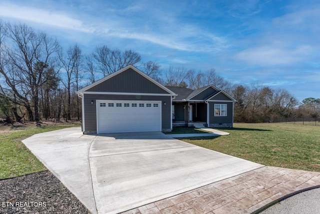 view of front facade featuring a garage, driveway, and a front lawn