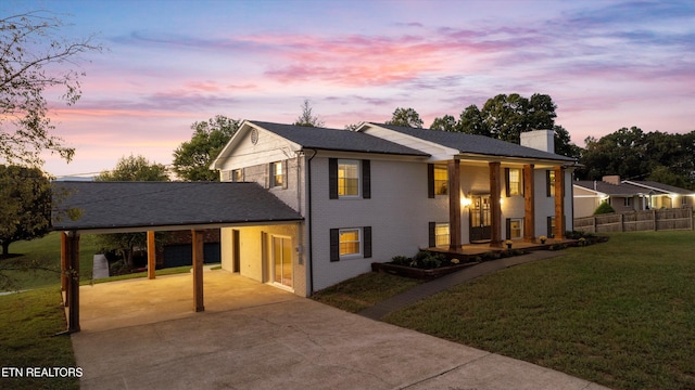 view of front of property with a garage and a lawn