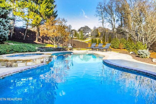 view of pool featuring an in ground hot tub and a patio