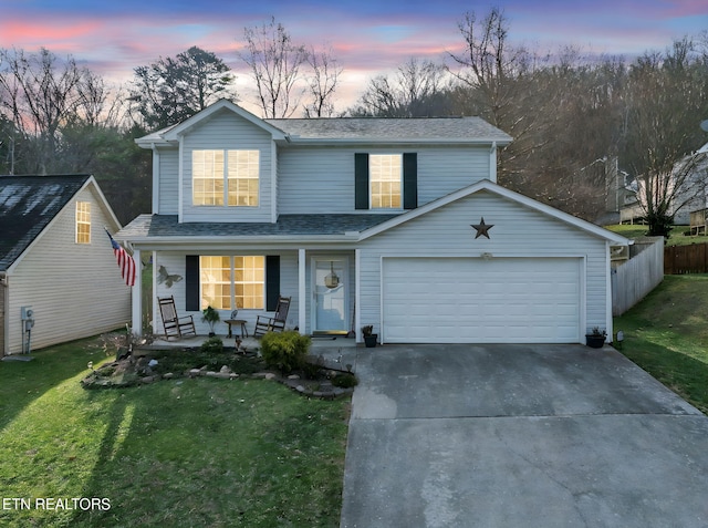 view of front property with covered porch and a lawn