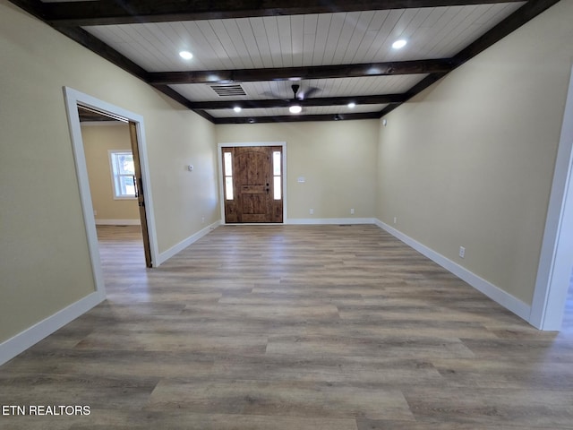 foyer with light wood finished floors, beamed ceiling, recessed lighting, and baseboards