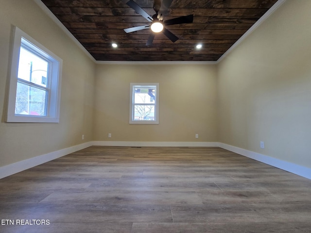 empty room with light wood-type flooring, wooden ceiling, and baseboards