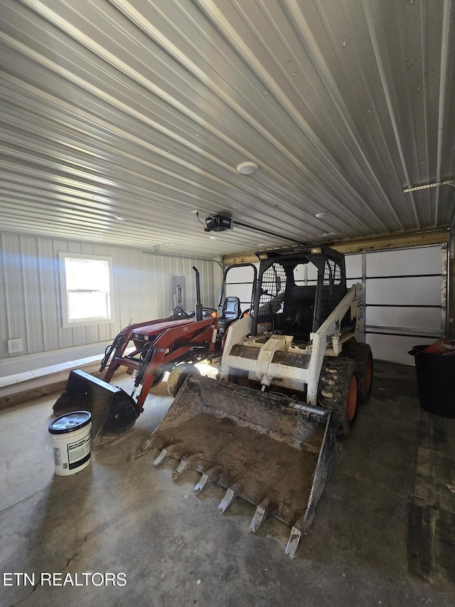 garage featuring metal wall and a garage door opener