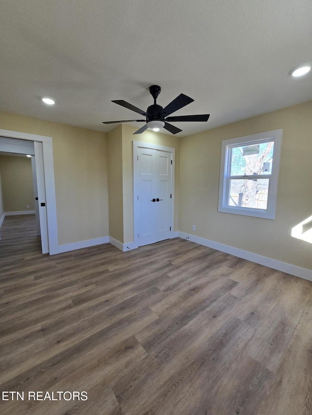 spare room featuring ceiling fan, baseboards, wood finished floors, and recessed lighting