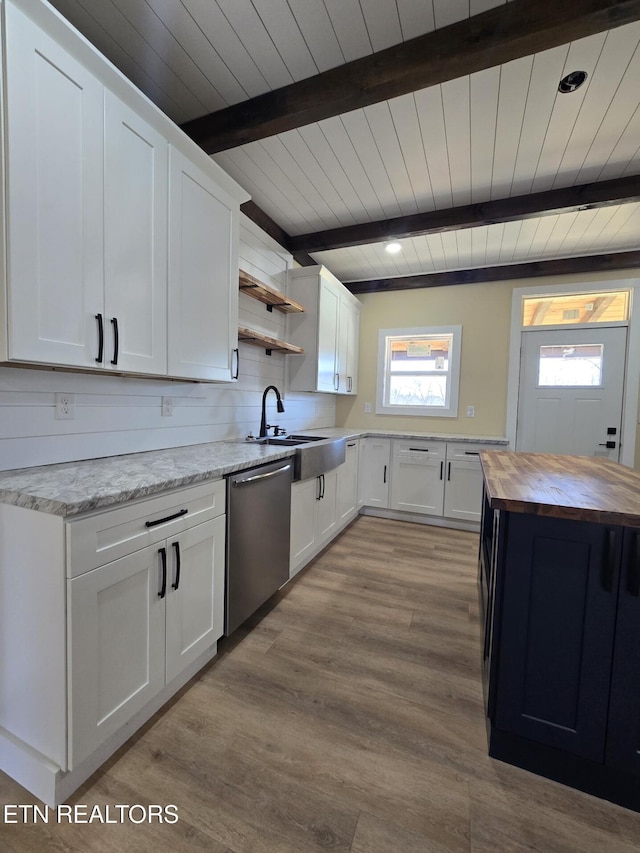 kitchen with a sink, white cabinets, wooden counters, dishwasher, and open shelves