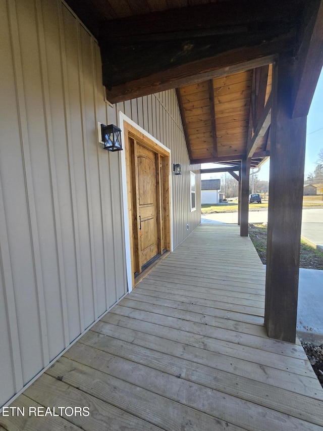 wooden terrace featuring covered porch