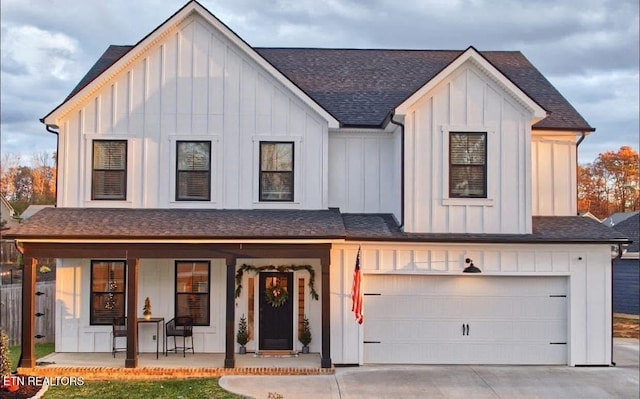 view of front of home with a garage and a porch