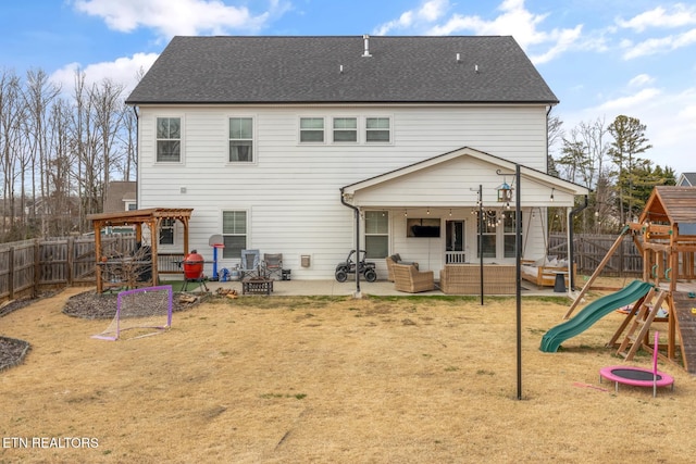 rear view of house with a lawn, a playground, outdoor lounge area, and a patio area