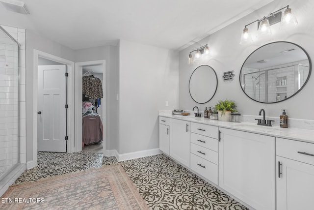 bathroom with tile patterned flooring, vanity, and an enclosed shower