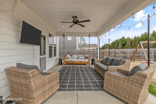 view of patio / terrace with a fenced backyard, outdoor lounge area, a ceiling fan, and a playground