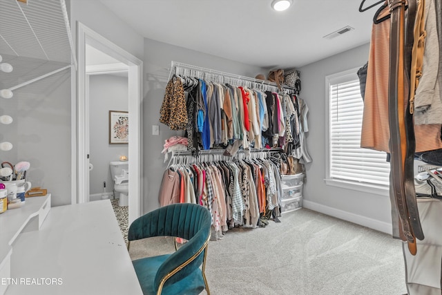 walk in closet with visible vents and carpet