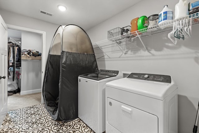laundry room with light carpet, visible vents, independent washer and dryer, and laundry area