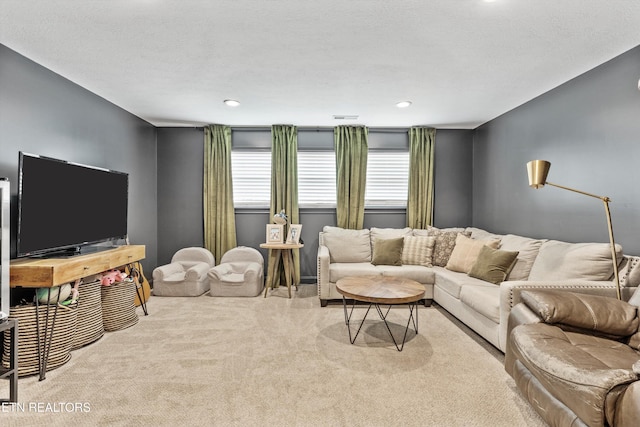 living area with carpet flooring, visible vents, and recessed lighting