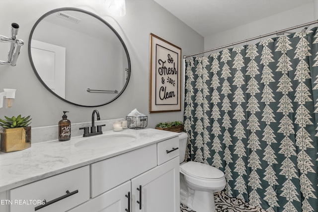 bathroom featuring visible vents, toilet, vanity, and a shower with curtain