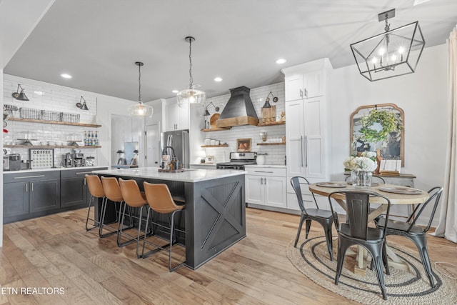 kitchen with open shelves, custom exhaust hood, and backsplash