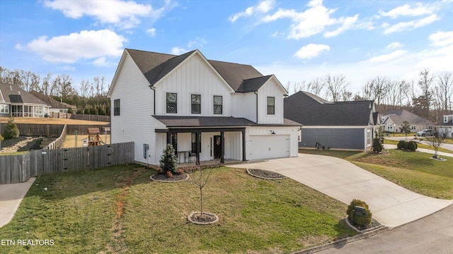 view of front of property with fence, board and batten siding, driveway, covered porch, and a front yard