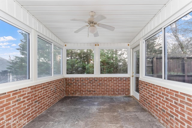 unfurnished sunroom featuring ceiling fan