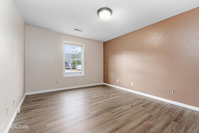 empty room featuring wood-type flooring