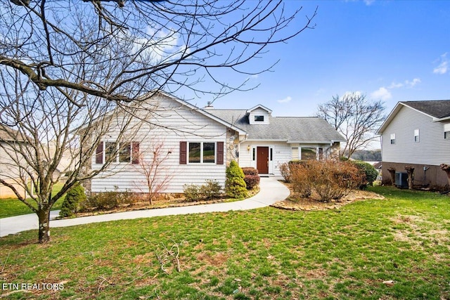 view of front of house featuring central air condition unit and a front lawn