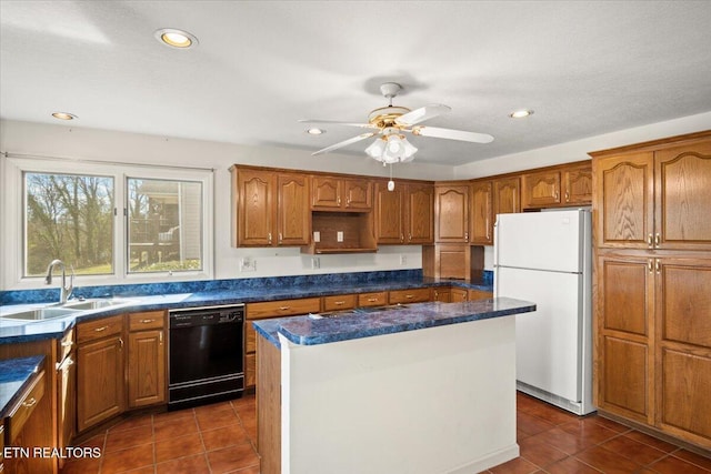 kitchen featuring a center island, dark tile patterned floors, dishwasher, freestanding refrigerator, and a sink