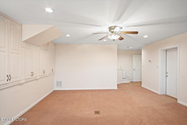 spare room with visible vents, a ceiling fan, recessed lighting, baseboards, and light colored carpet