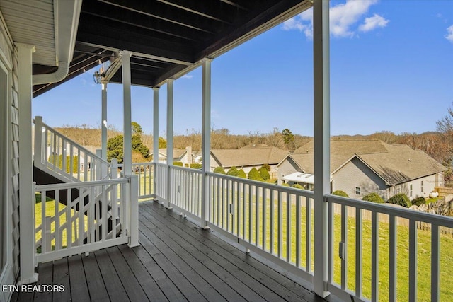 wooden deck featuring a yard and a residential view