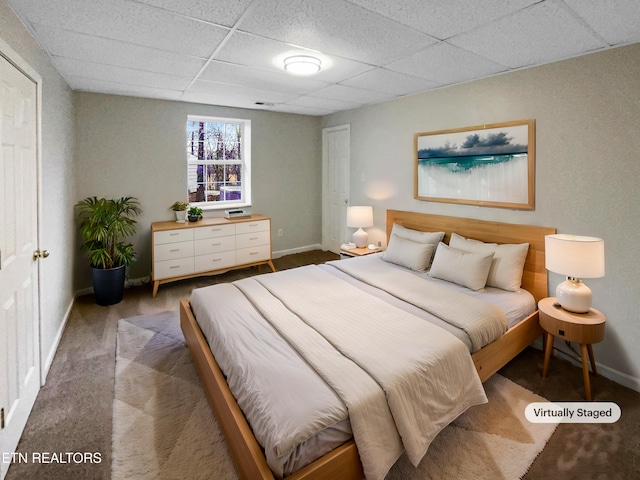 carpeted bedroom with a drop ceiling