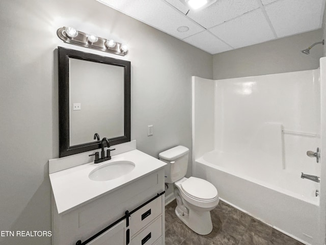 full bathroom with vanity, a paneled ceiling, bathing tub / shower combination, and toilet