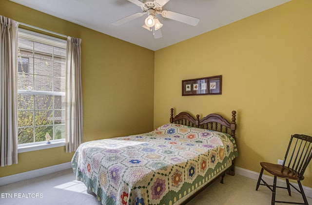 bedroom featuring ceiling fan and light carpet