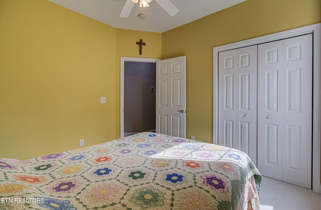 carpeted bedroom with ceiling fan and a closet