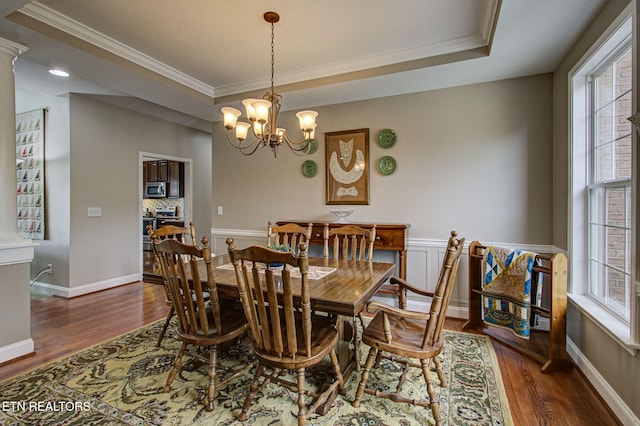 dining room featuring crown molding, a healthy amount of sunlight, and dark hardwood / wood-style floors