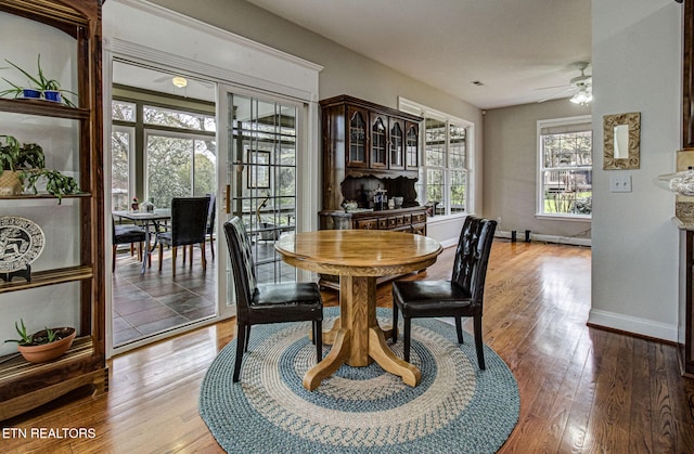 dining area with hardwood / wood-style flooring and ceiling fan