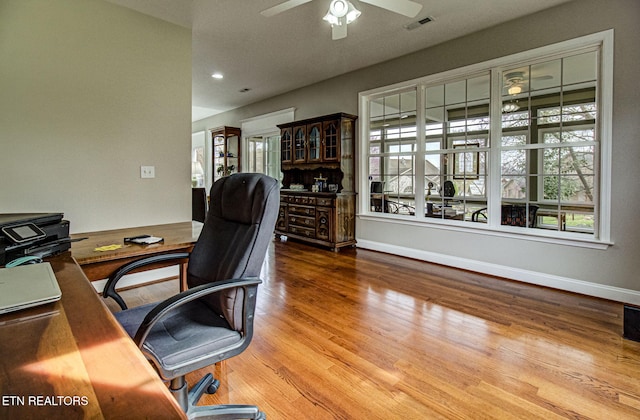 home office featuring hardwood / wood-style flooring and ceiling fan