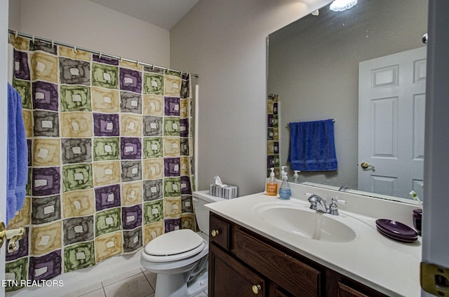 bathroom featuring tile patterned flooring, vanity, and toilet